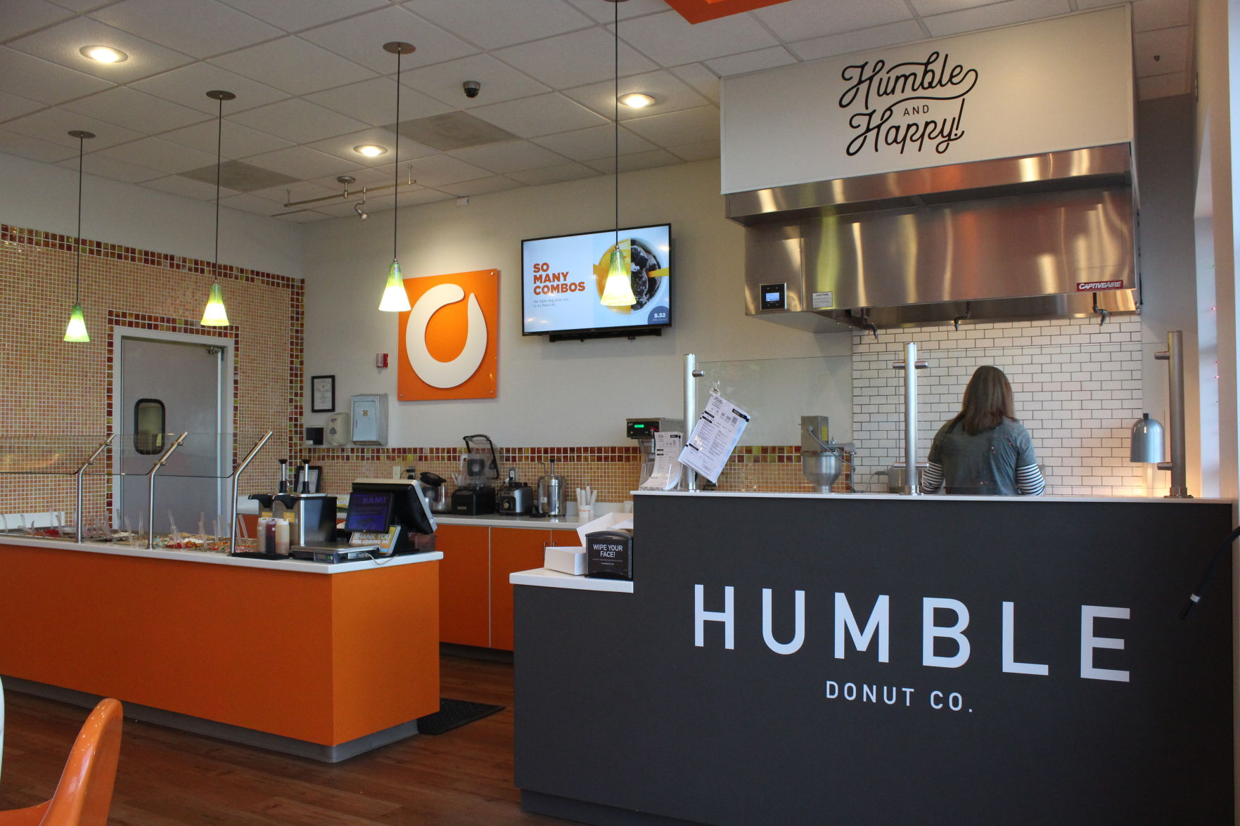 The inside of the Orange Leaf store has two counters: One for frozen yogurt and one for doughnuts